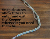 Text says "Snap closures allow tubes to enter and exit the Keeper wherever you need them to."